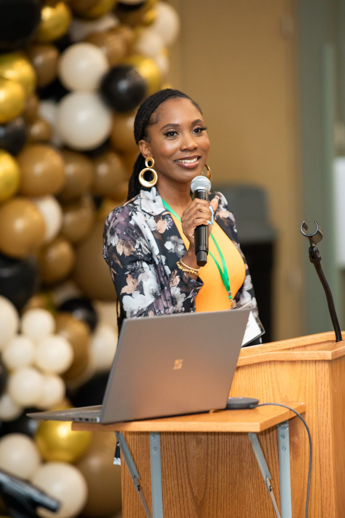 Shontelle Brewster speaking into a microphone at an event