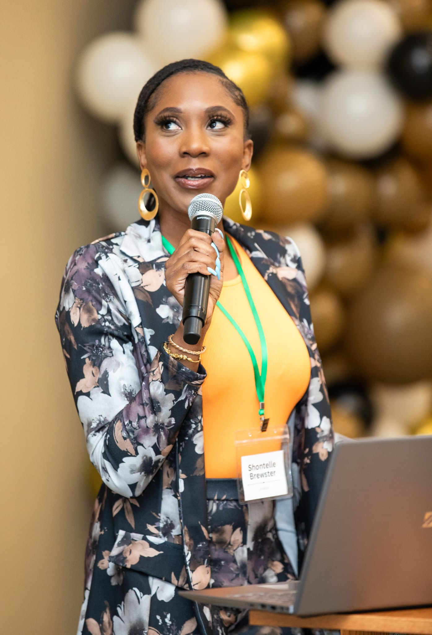 Shontelle Brewster presenting with a microphone